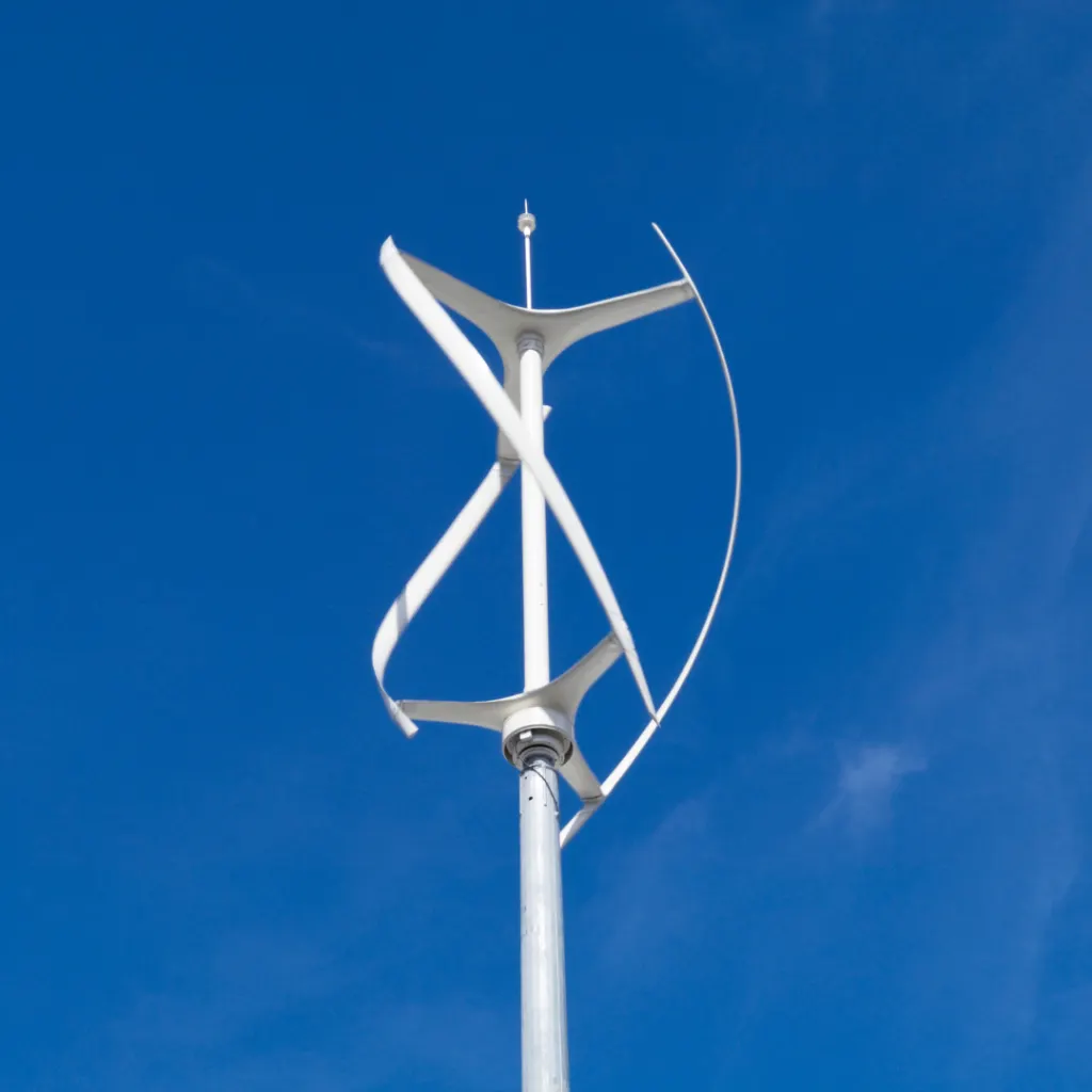 A Darrieus-type vertical-axis wind turbine mounted on a pole against a clear blue sky